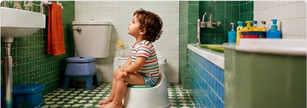 Toddler sitting on a potty in a bathroom.